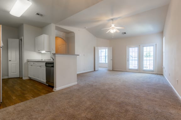 Wooden flooring with ceiling fan and light in living room at Wynnewood Farms Apartments, Overland Park, Kansas