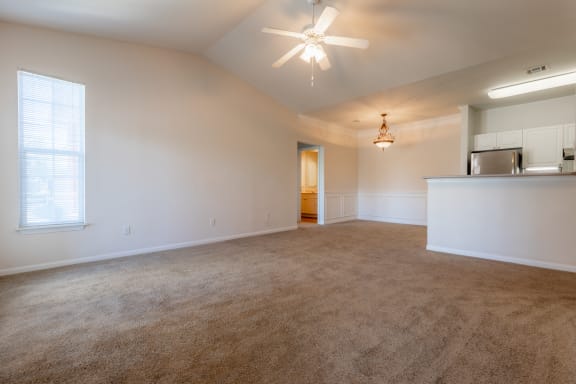 Wooden flooring with ceiling fan and light in living room , dining and kitchen at Wynnewood Farms Apartments, Kansas