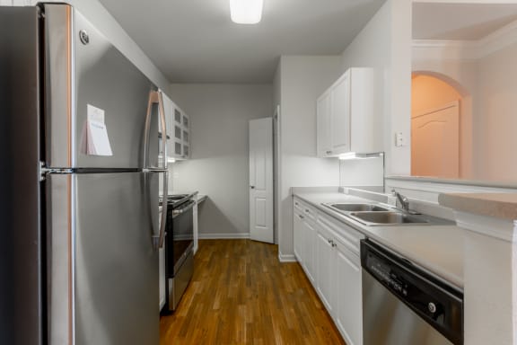 Kitchen area with appliances and cabinets at Wynnewood Farms Apartments, Kansas, 66209