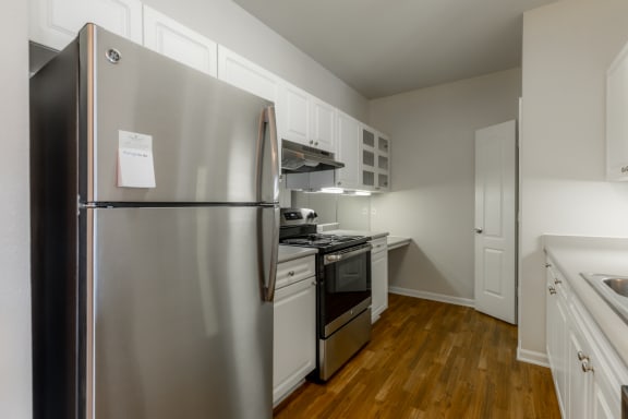 Kitchen area with appliances and cabinets1 at Wynnewood Farms Apartments, Overland Park, KS, 66209