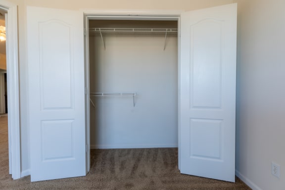 Bedroom with closet at Wynnewood Farms Apartments, Overland Park, KS