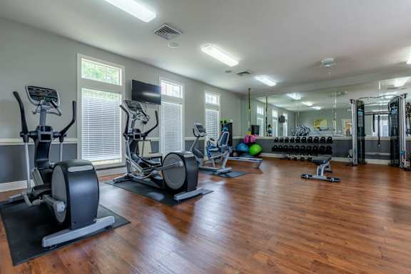 Fitness Center equipped with exercise bikes, yoga balls, free weights, and more at Stonebriar Woods Apartments.