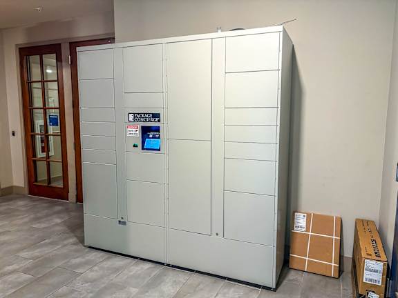 Secure package lockers at The Dorset Apartments with digital screen for convenient resident access.