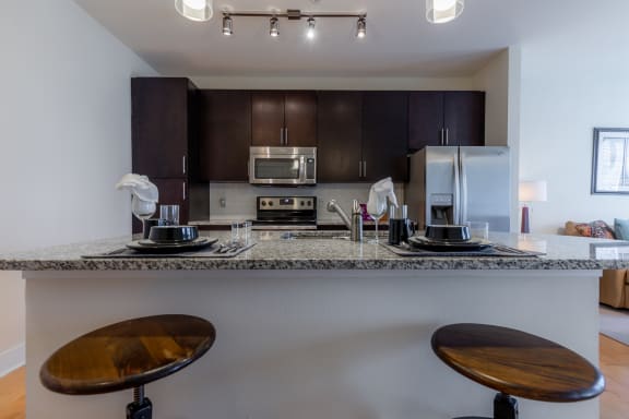 Kitchen breakfast bar with chair at West 39th Street Apartments, Missouri