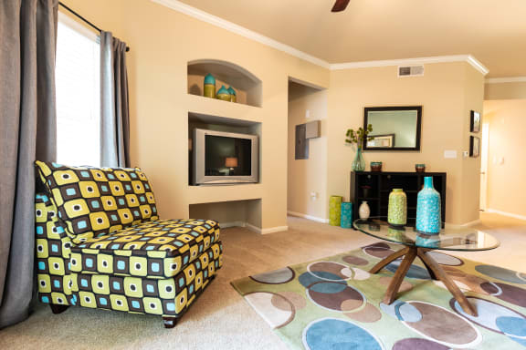 living room with furniture and built in entertainment center within two bedroom floorplan at Wade Crossing Apartment Homes , Texas