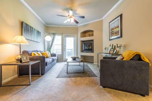 one bedroom living room area decor with furniture at Wade Crossing Apartment Homes , Texas