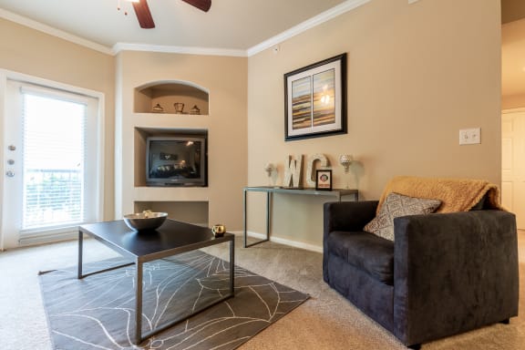 one bedroom living room area with furniture and built-in entertainment center at Wade Crossing Apartment Homes , Frisco, Texas