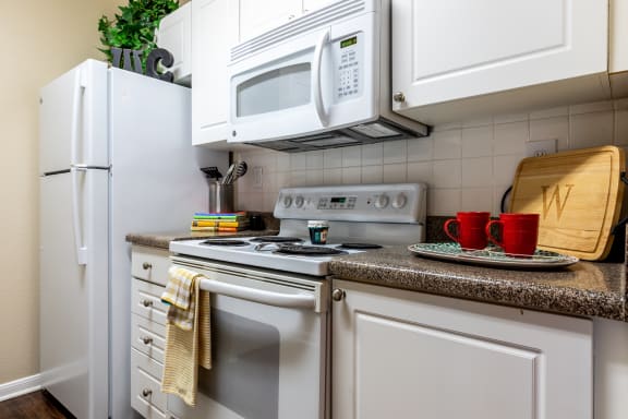 kitchen appliances within one bedroom apartment showing microwave and stove at Wade Crossing Apartment Homes , Frisco, Texas,TX