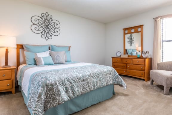 Bedroom with cozy bedat Cloverset Valley Apartments, Kansas City, MO, 64114
