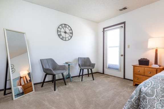 Bedroom with cozy bed, mirror and cabinetsat Cloverset Valley Apartments, Kansas City, MO