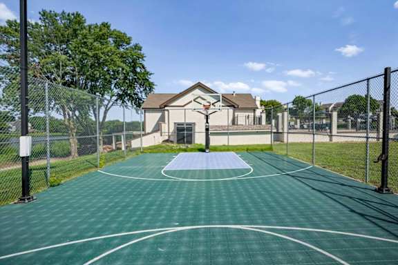 Basketball court located adjacent to the community pool area and overlooking the lake at Millcreek Woods.