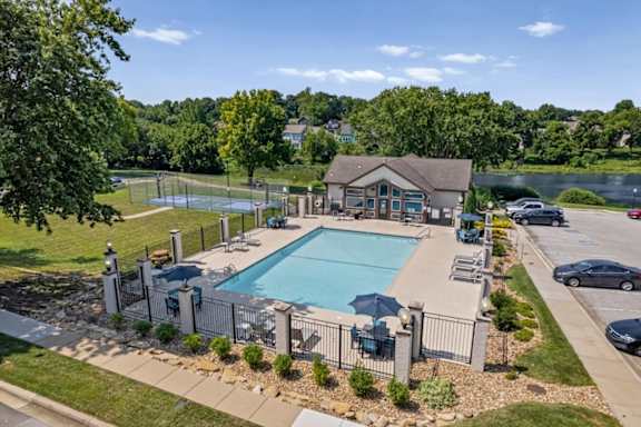Elevated view of the swimming pool, sundeck, basketball court, and surrounding amenities at Millcreek Woods.