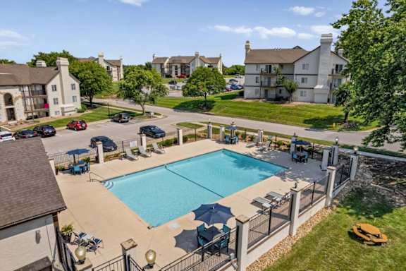 Elevated view of the outdoor swimming pool featuring lounge seating and community gathering areas.