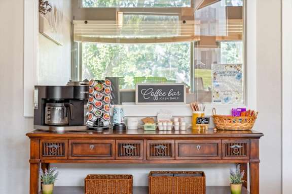 Coffee station with beverage supplies and resident refreshments inside the clubhouse.