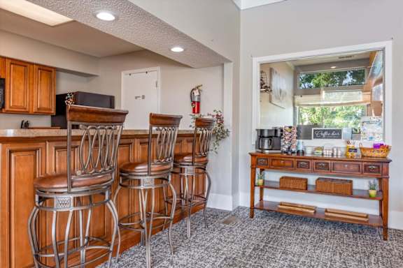 Resident clubhouse seating area with coffee station and community gathering space.