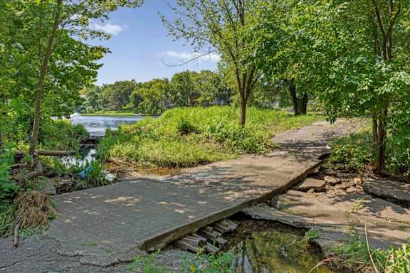 Walking path crossing a landscaped creek near the community lake.