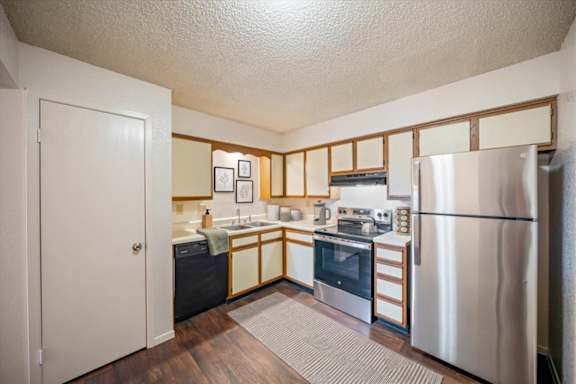 Apartment kitchen featuring stainless steel appliances, cabinetry, and ample countertop space.
