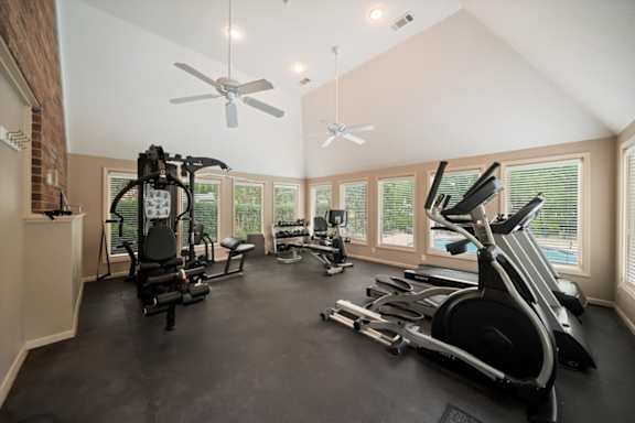 A spacious home gym with a variety of exercise equipment.