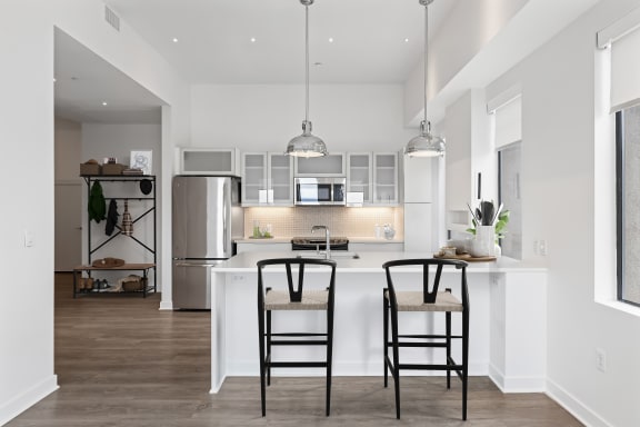 a kitchen with a large island with two stools