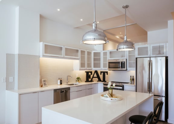 a kitchen with an eat sign on the wall at Sky on Main, 64105
