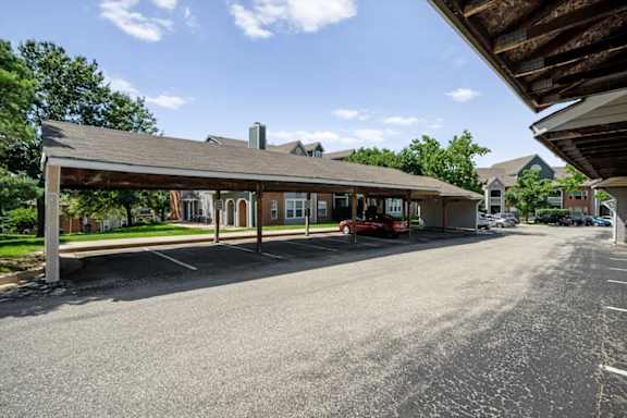 Covered carports with parking spaces at Stonebriar Apartments in Overland Park, Kansas