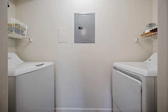 Laundry closet with washer and dryer inside Stonebriar Apartments unit