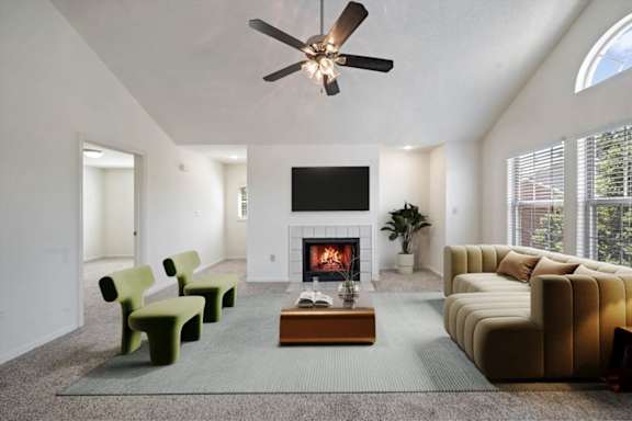 Bright living room with fireplace and high ceiling at Stonebriar Apartments Overland Park KS