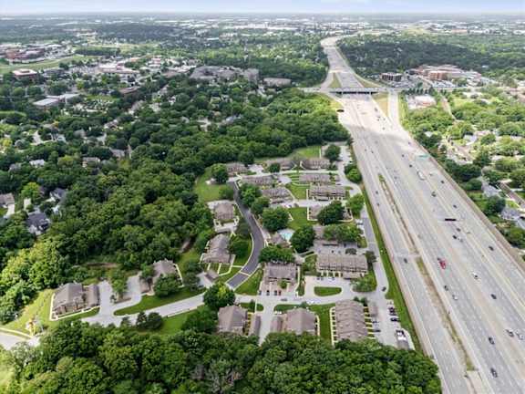 An aerial view of Waterford Place Apartments & Townhomes, located right next to a major highway