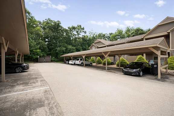 A parking lot with covered parking at Waterford Place Apartments & Townhomes