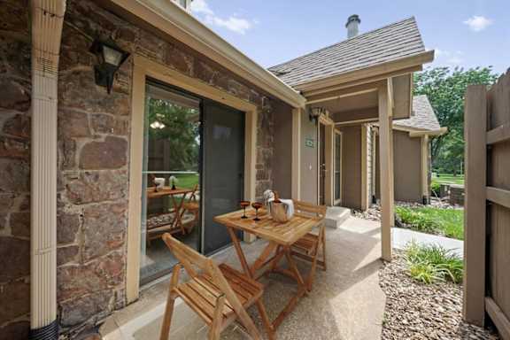 A furnished patio with direct access to inside the home at Waterford Place Apartments & Townhomes