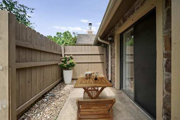 A furnished patio with direct access to inside the home at Waterford Place Apartments & Townhomes