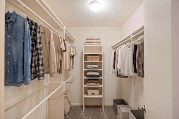 A large walk-in closet with a shoe rack at Waterford Place Apartments & Townhomes in Overland Park, KS