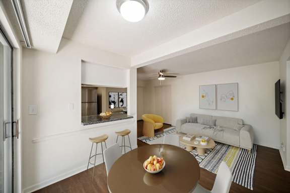 Dining space connected to the kitchen and living area with breakfast bar seating and contemporary staging.
