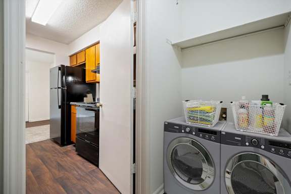 Laundry area located adjacent to the kitchen in a Wind River Lodge apartment home.