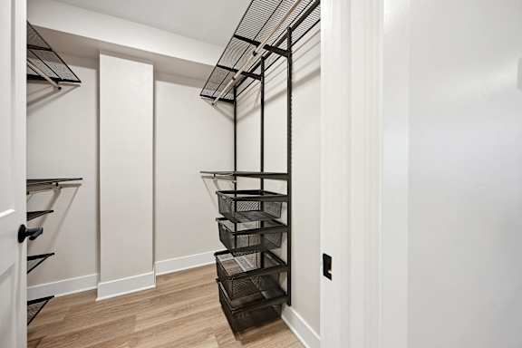 a room with a staircase and a closet with a mirrored door