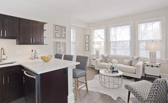 a living room with a kitchen and a couch and a table