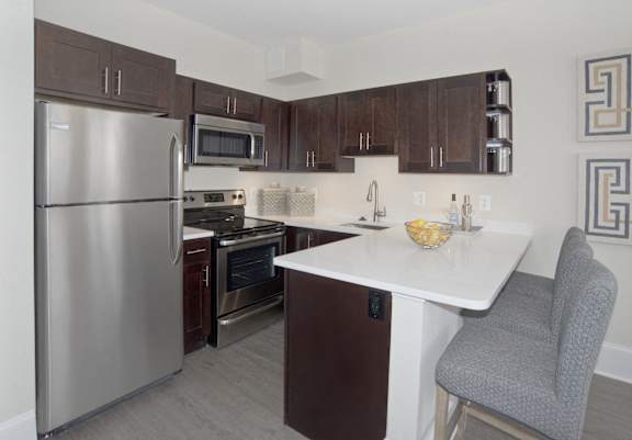 a kitchen with stainless steel appliances and a white counter top