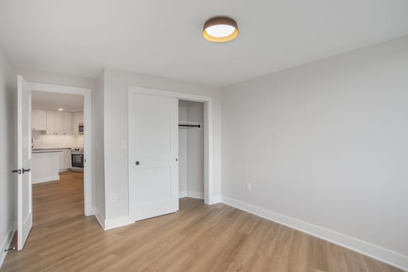 A room with a white door and a white wall.
