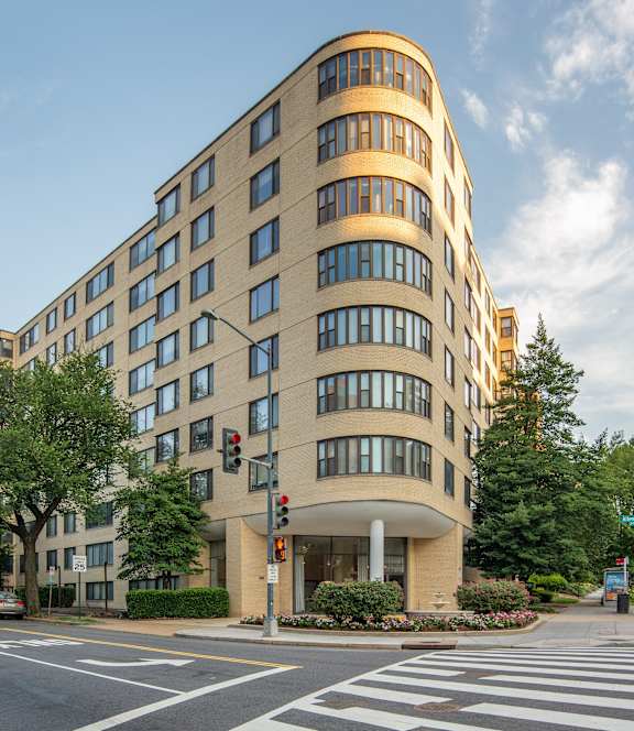 a tall building on the corner of a city street