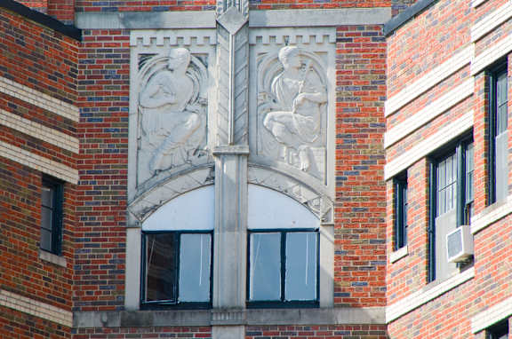 A building with a large window and a sculpture above it.