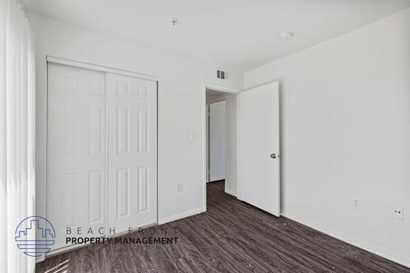 a bedroom with two closets and a door to a hallway