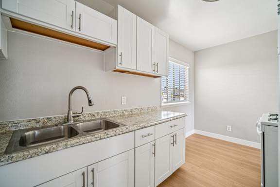 A kitchen with a sink and cabinets.