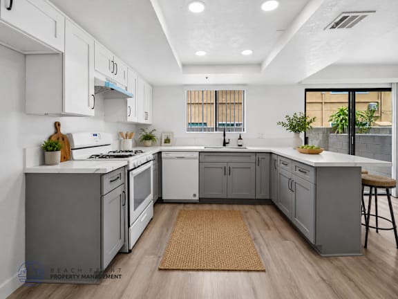 A modern kitchen with white cabinets and a central island.