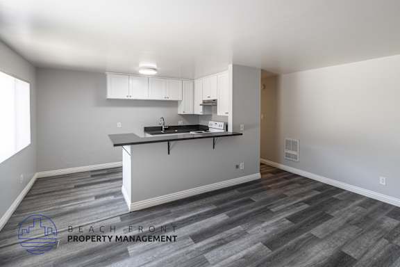 A kitchen area with a counter and cabinets.