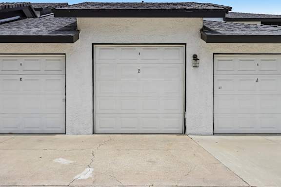 Three garage doors are closed and labeled A, B, and C.