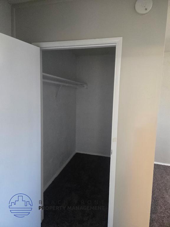 A small, empty room with a doorway leading to another room.