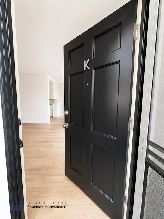 A black door with a letter K on it.