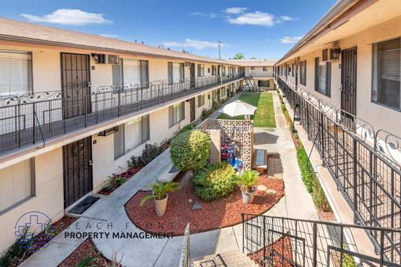 a courtyard with a lawn and plants in the middle of a building