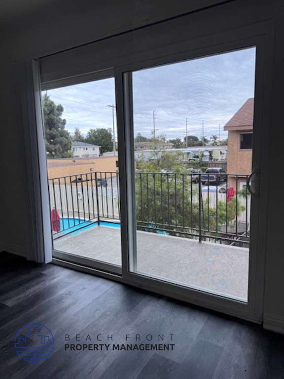 A view from inside a room looking out through a sliding glass door.
