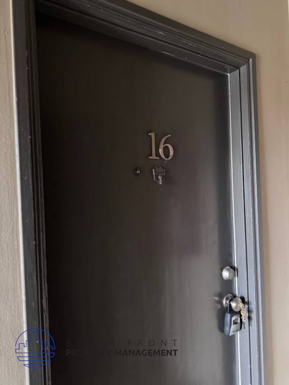 A black door with the number 16 on it.